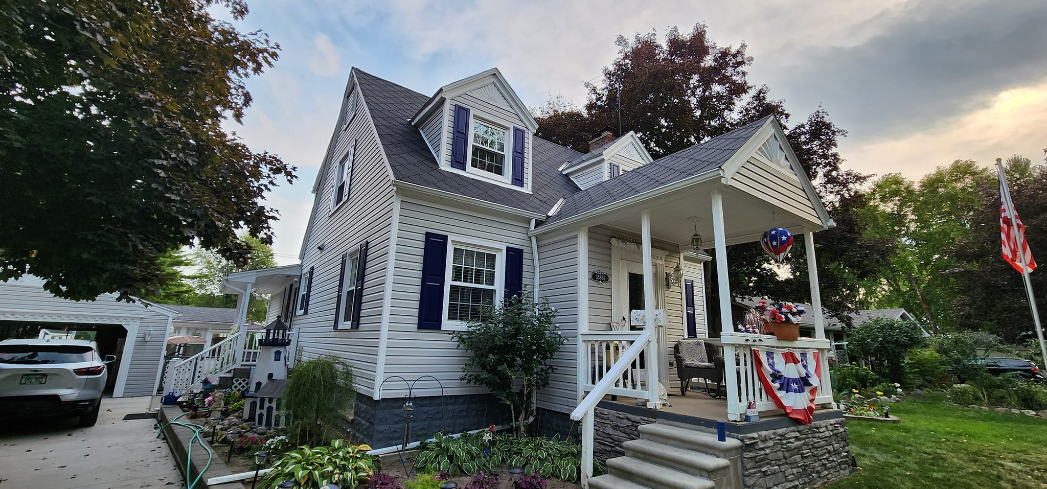 Exterior of white-sided home with blue shutters