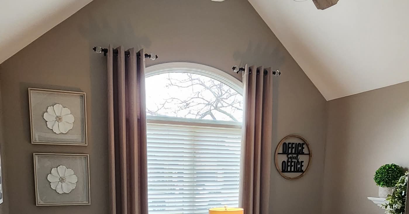 Office with gray taupe vaulted ceiling and curtains